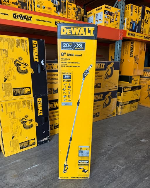 The box for a dewalt pole saw with other dewalt tools in the background.