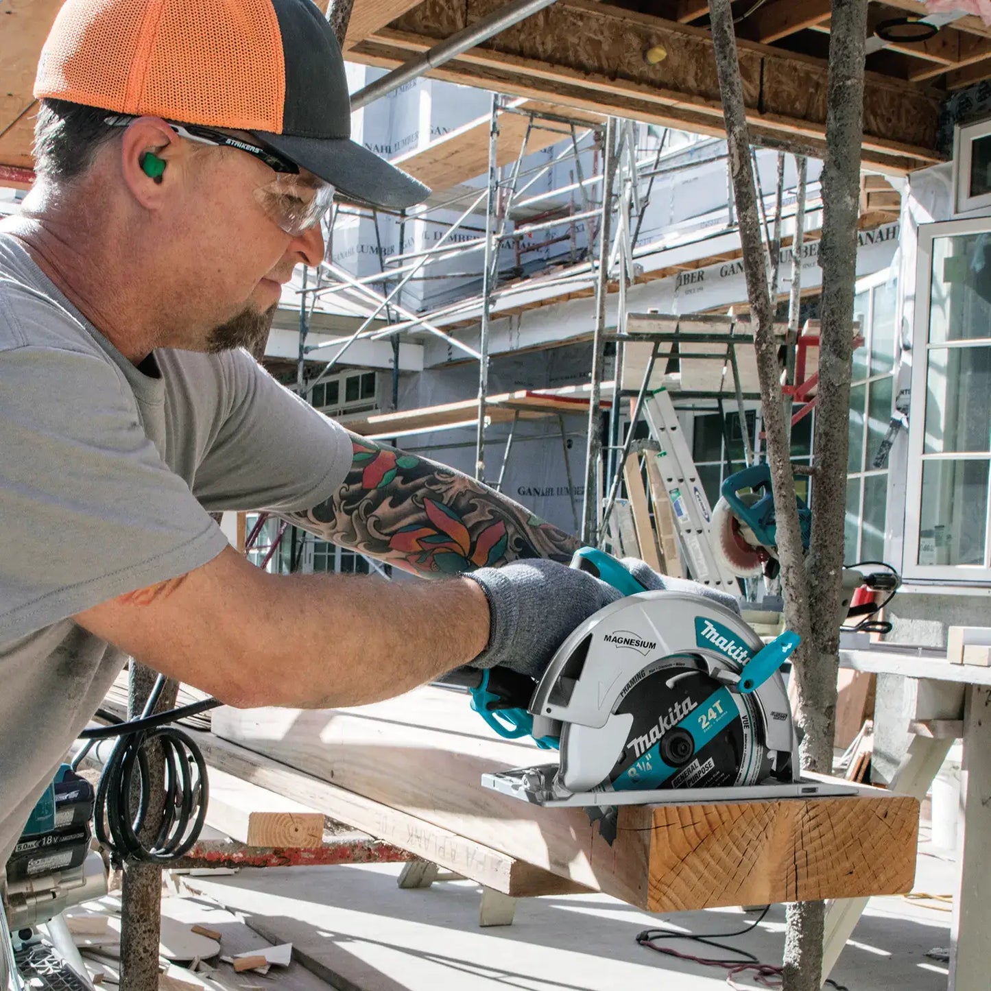 Man using a circular saw on a construction site