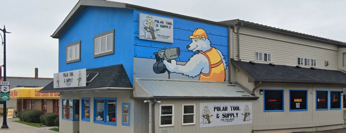Building with a mural of a bear using a nailgun on a blue wall.