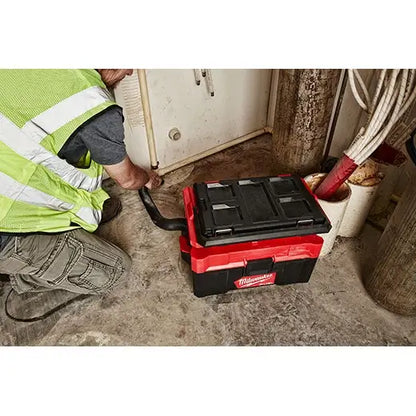 Person using a Milwaukee toolbox in a construction setting