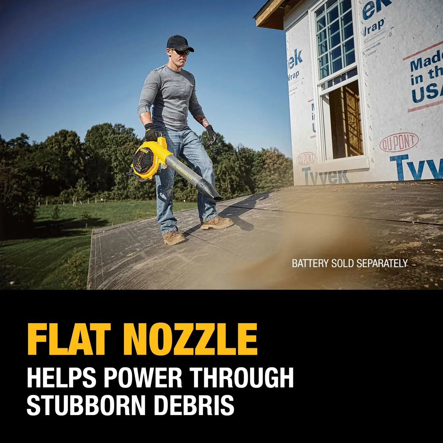 Person holding a leaf blower with text about a flat nozzle in front of a house under construction.