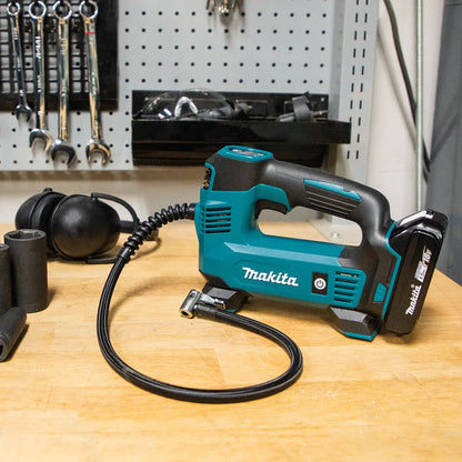 Makita power tool on a workbench with tools in the background