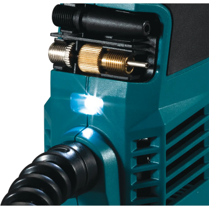 Close-up of a teal power tool with a black nozzle and brass fitting on a white background