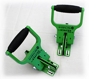 Two green tools with black handles on a white background